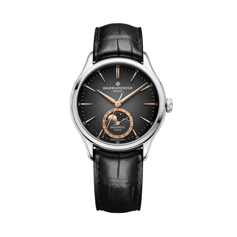 Baume & Mercier Clifton er en dressklokke med månefase til herre på 39 mm. Kasse i stål og rem i alligatorskinn. 50 meter vanntett. Baume & Mercier Clifton er en dressklokke med månefase til herre på 39 mm. Kasse i stål og rem i alligatorskinn. 50 meter vanntett.