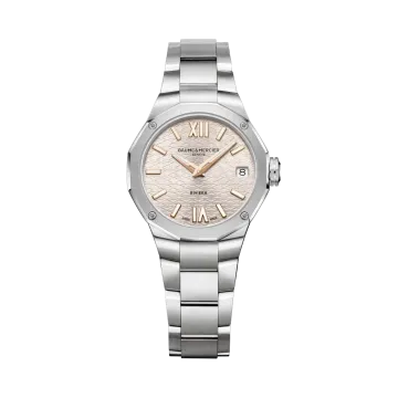 Baume & Mercier Rivera dameklokke med quartzverk på 33 mm. Kasse og lenke i stål, og en champagnefarget skive. 50 meter vanntett.